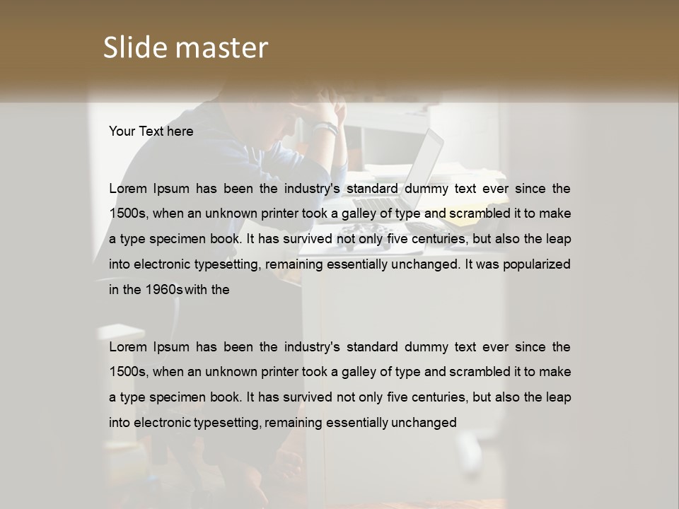 A Man Sitting At A Desk In Front Of A Laptop Computer PowerPoint Template