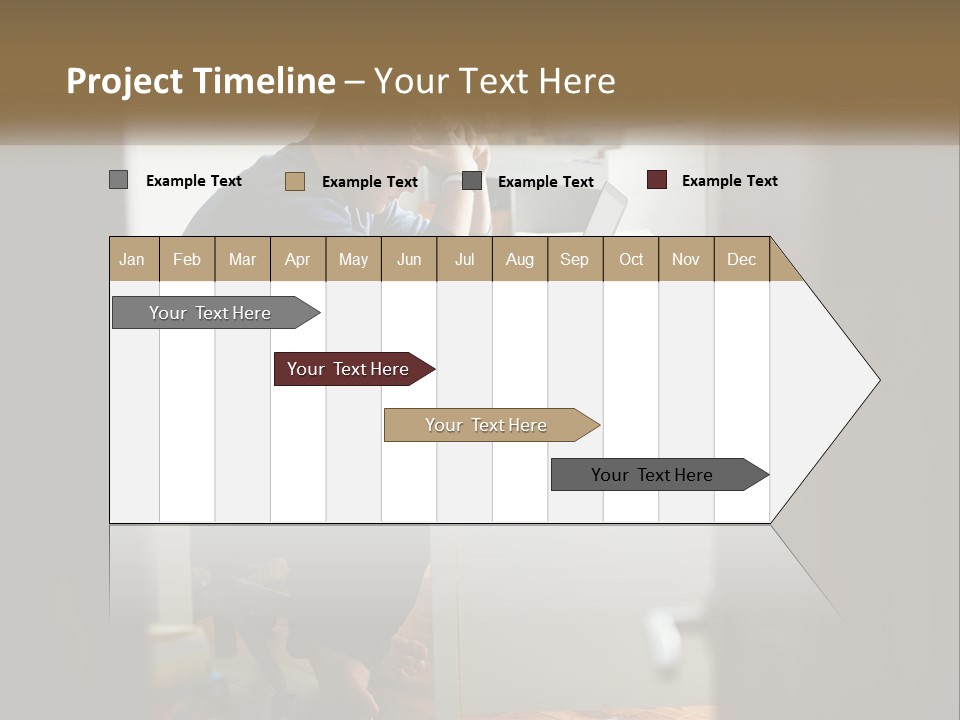 A Man Sitting At A Desk In Front Of A Laptop Computer PowerPoint Template