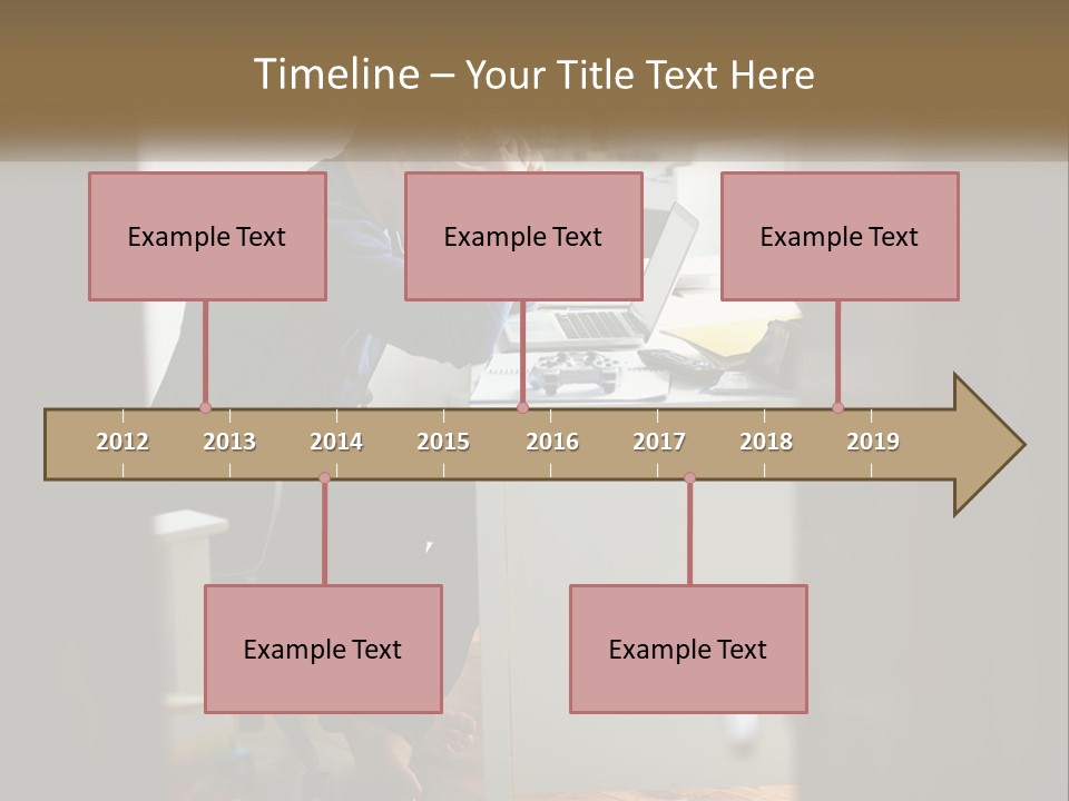 A Man Sitting At A Desk In Front Of A Laptop Computer PowerPoint Template