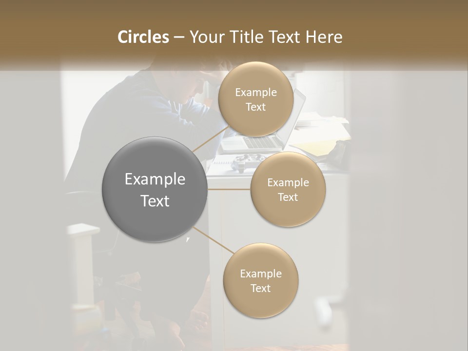 A Man Sitting At A Desk In Front Of A Laptop Computer PowerPoint Template