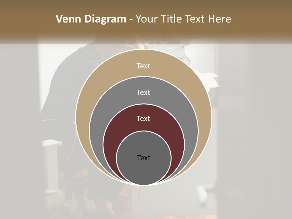 A Man Sitting At A Desk In Front Of A Laptop Computer PowerPoint Template