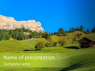 A Green Field With A Mountain In The Background PowerPoint Template