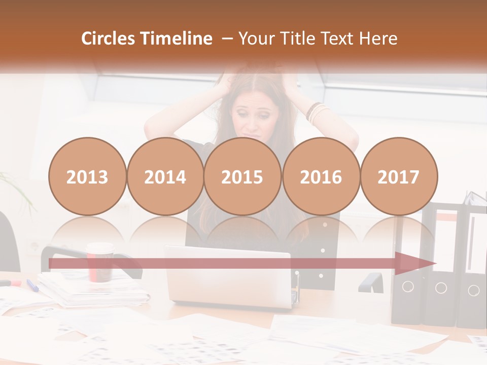 A Woman Sitting At A Desk With A Laptop PowerPoint Template