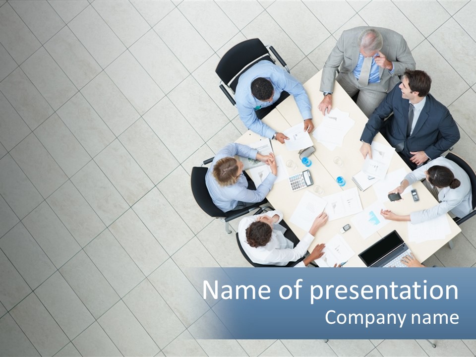 A Group Of People Sitting Around A Table PowerPoint Template
