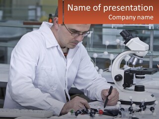 A Man Sitting At A Desk In Front Of A Microscope PowerPoint Template