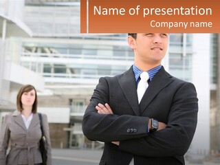 A Man In A Suit Standing With His Arms Crossed PowerPoint Template