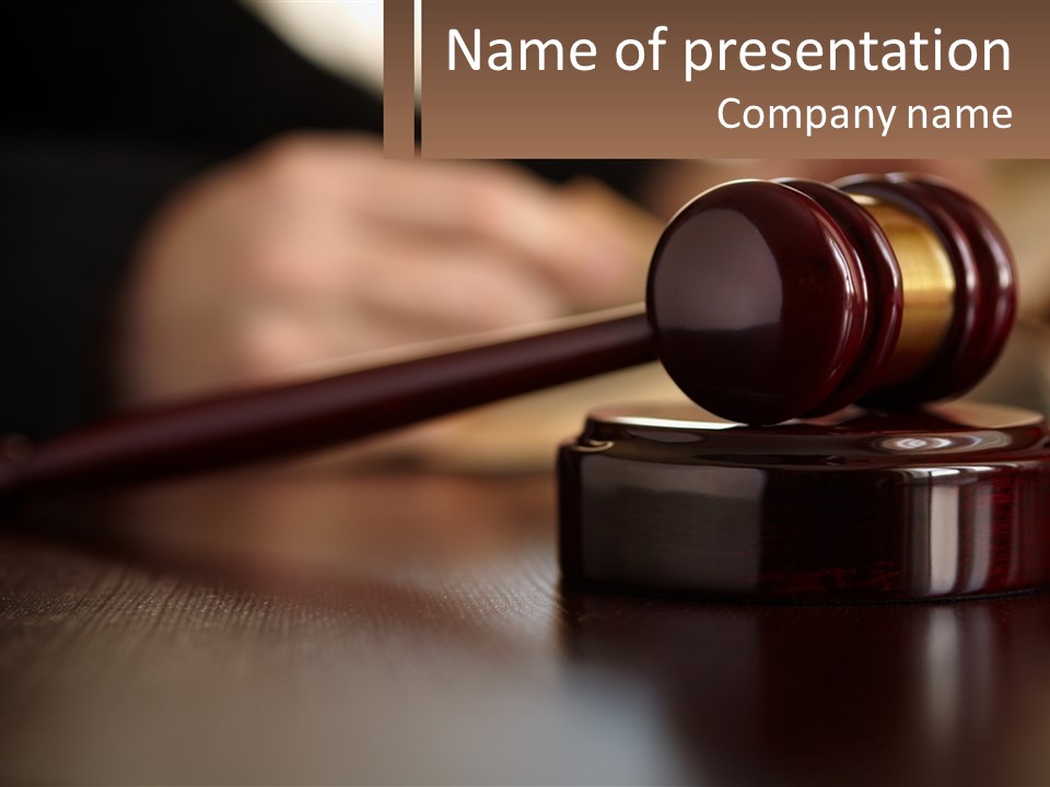A Wooden Judge's Gavel Sitting On Top Of A Wooden Table PowerPoint Template