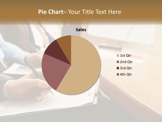 A Group Of People Sitting At A Conference Table PowerPoint Template