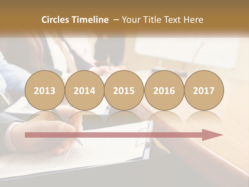 A Group Of People Sitting At A Conference Table PowerPoint Template