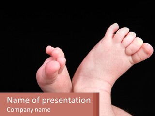 A Baby's Foot With A Black Background PowerPoint Template