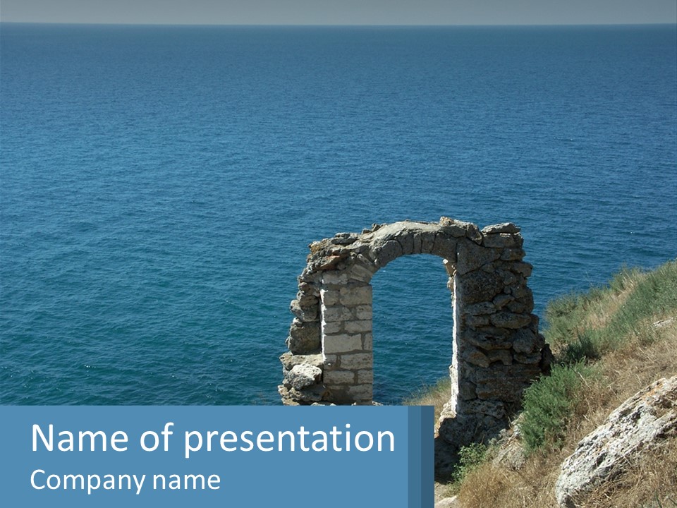 A Stone Arch On A Cliff Overlooking The Ocean PowerPoint Template