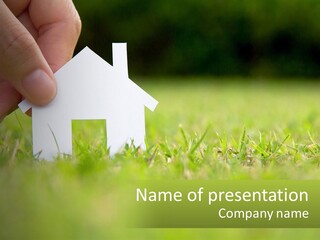 A Person Holding A Paper House In The Grass PowerPoint Template