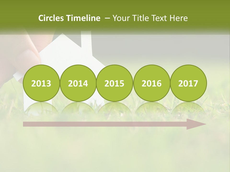 A Person Holding A Paper House In The Grass PowerPoint Template