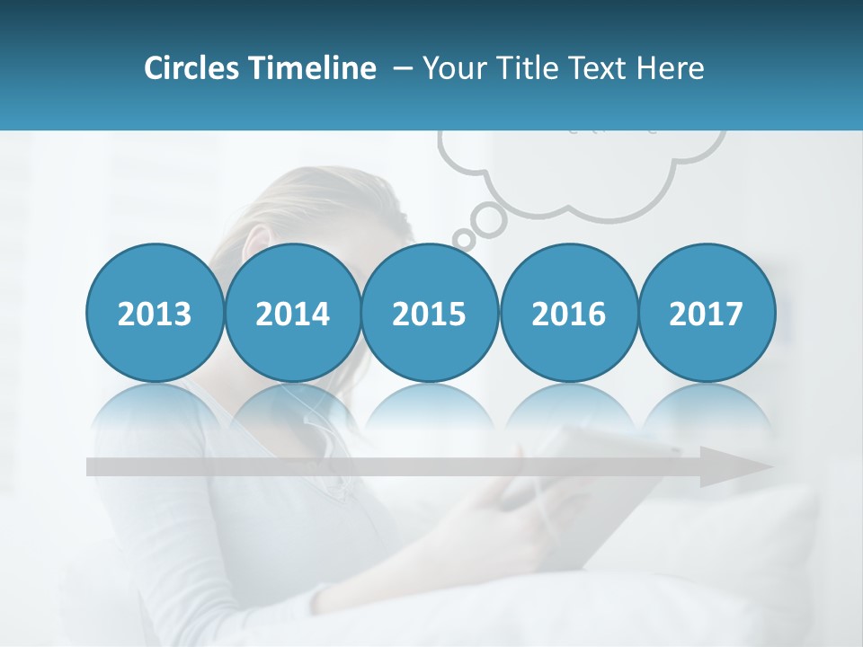 A Woman Sitting On A Couch Looking At A Tablet PowerPoint Template