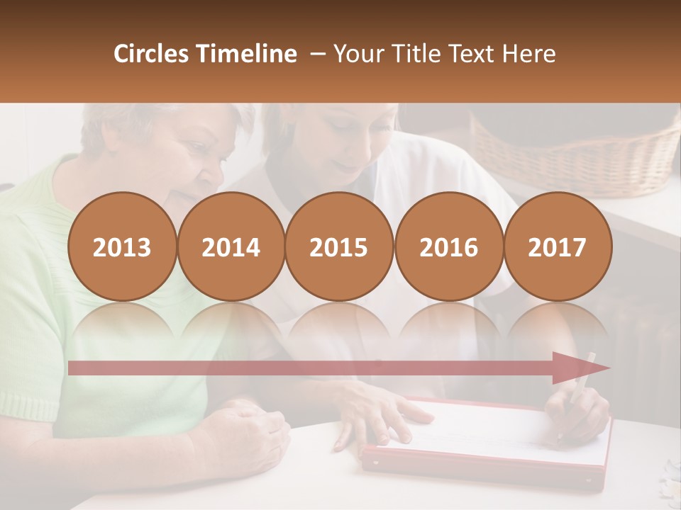 A Woman Sitting Next To A Woman Who Is Writing On A Piece Of Paper PowerPoint Template