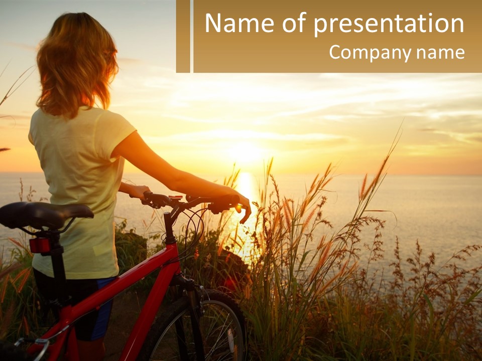 A Woman Riding A Bike Near The Ocean At Sunset PowerPoint Template