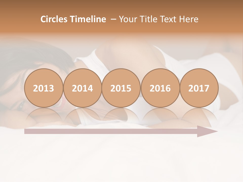 A Woman Laying On A Bed Smiling For The Camera PowerPoint Template