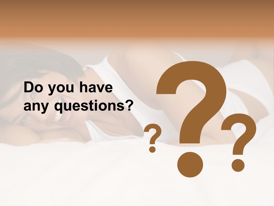 A Woman Laying On A Bed Smiling For The Camera PowerPoint Template