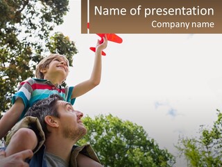 A Man Holding A Small Child On His Shoulders PowerPoint Template