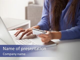 A Woman Holding A Credit Card While Using A Laptop PowerPoint Template