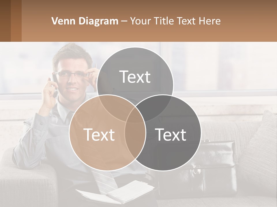 A Man Sitting On A Couch Talking On A Cell Phone PowerPoint Template