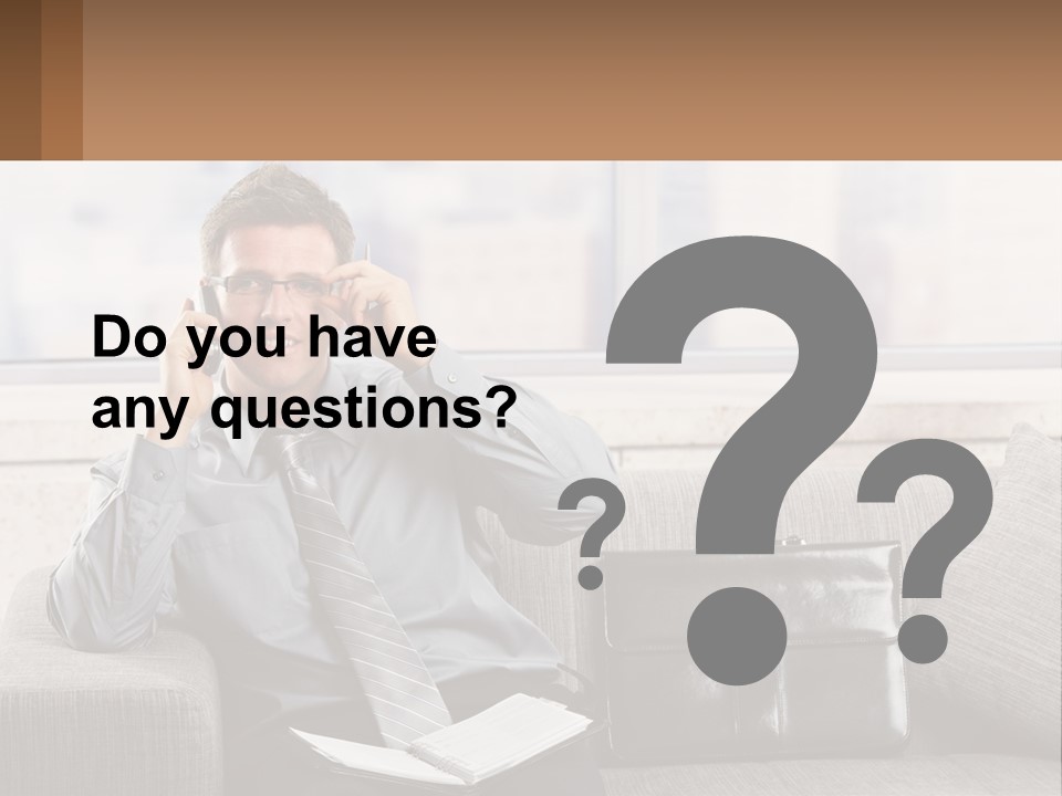 A Man Sitting On A Couch Talking On A Cell Phone PowerPoint Template