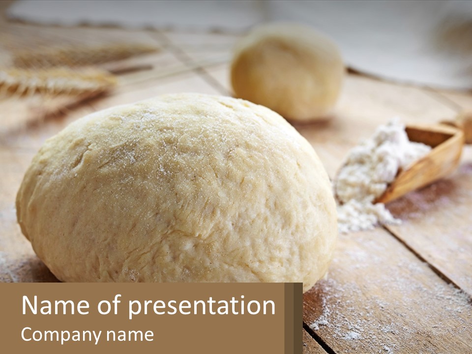 A Ball Of Bread Sitting On Top Of A Wooden Table PowerPoint Template