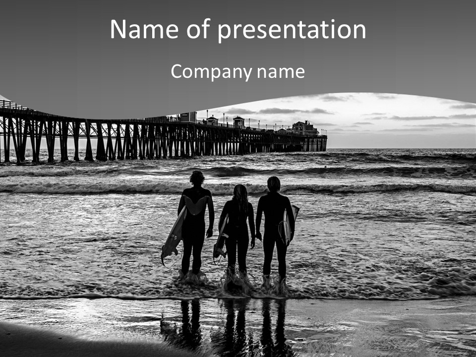 Three Surfers Standing On The Beach With A Pier In The Background PowerPoint Template