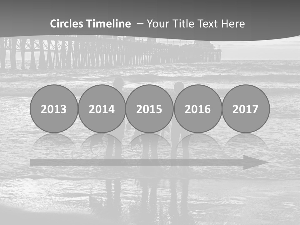 Three Surfers Standing On The Beach With A Pier In The Background PowerPoint Template