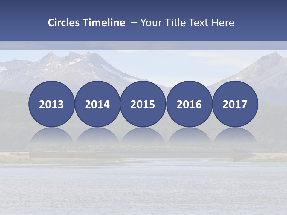 A Lake With Mountains In The Background And A Blue Sky PowerPoint Template