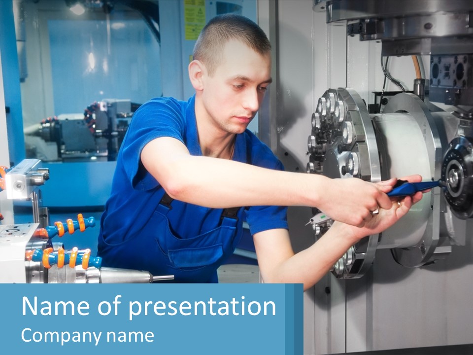 A Man Working On A Machine In A Factory PowerPoint Template
