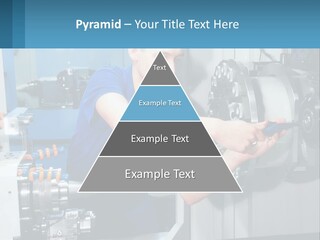 A Man Working On A Machine In A Factory PowerPoint Template