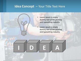 A Man Working On A Machine In A Factory PowerPoint Template