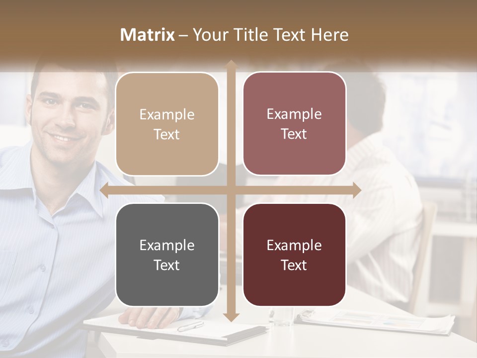 A Man Sitting At A Desk In Front Of A Group Of People PowerPoint Template
