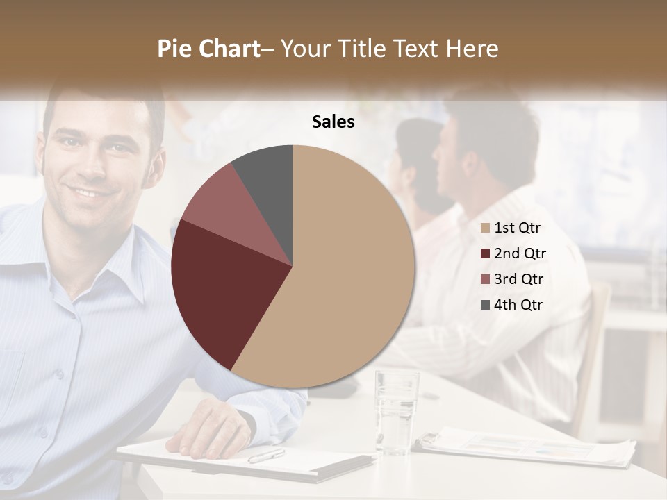 A Man Sitting At A Desk In Front Of A Group Of People PowerPoint Template