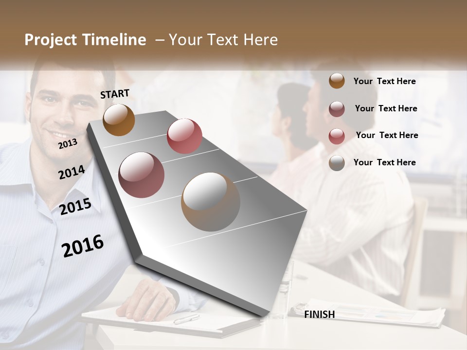 A Man Sitting At A Desk In Front Of A Group Of People PowerPoint Template