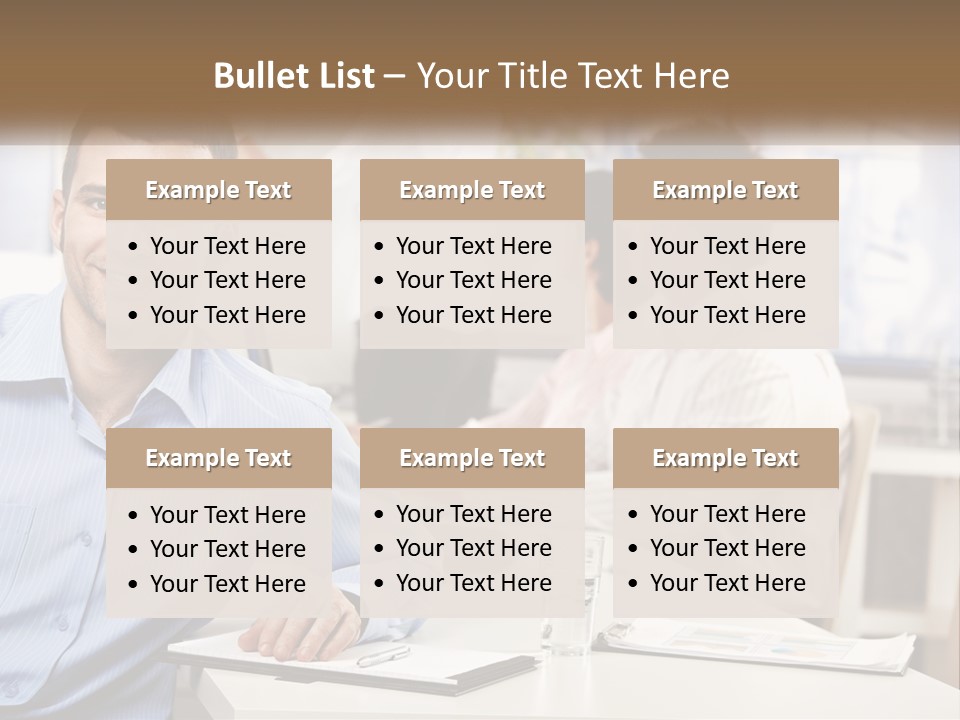 A Man Sitting At A Desk In Front Of A Group Of People PowerPoint Template