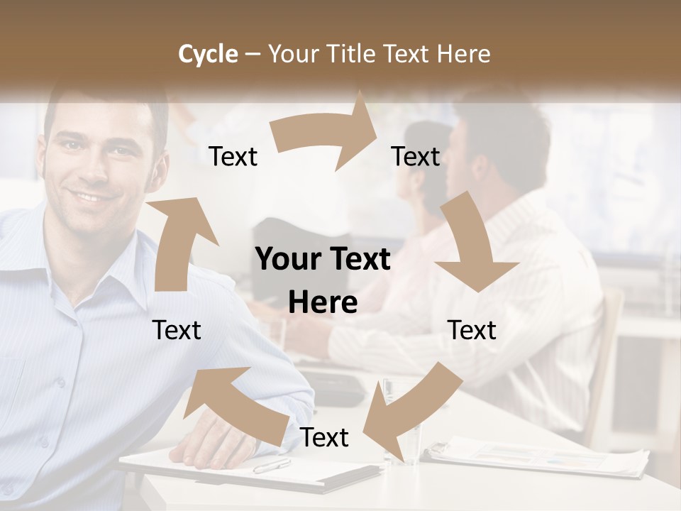 A Man Sitting At A Desk In Front Of A Group Of People PowerPoint Template