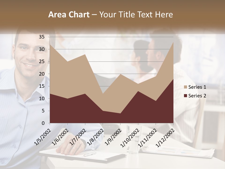 A Man Sitting At A Desk In Front Of A Group Of People PowerPoint Template