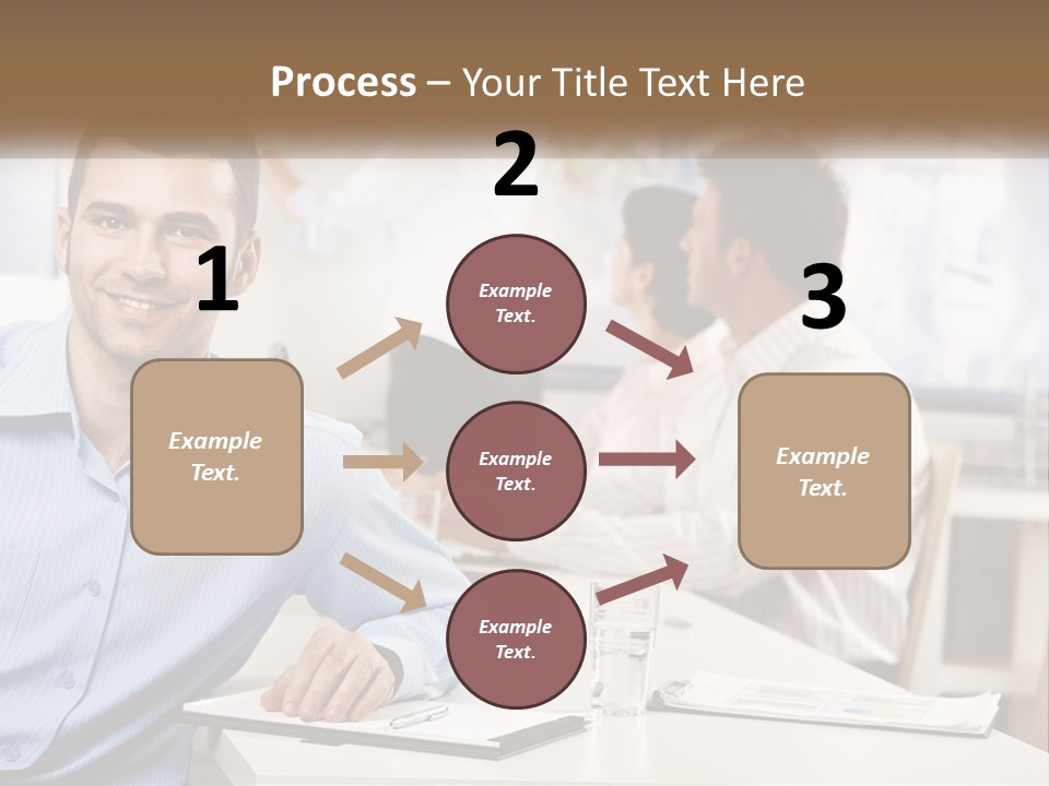 A Man Sitting At A Desk In Front Of A Group Of People PowerPoint Template