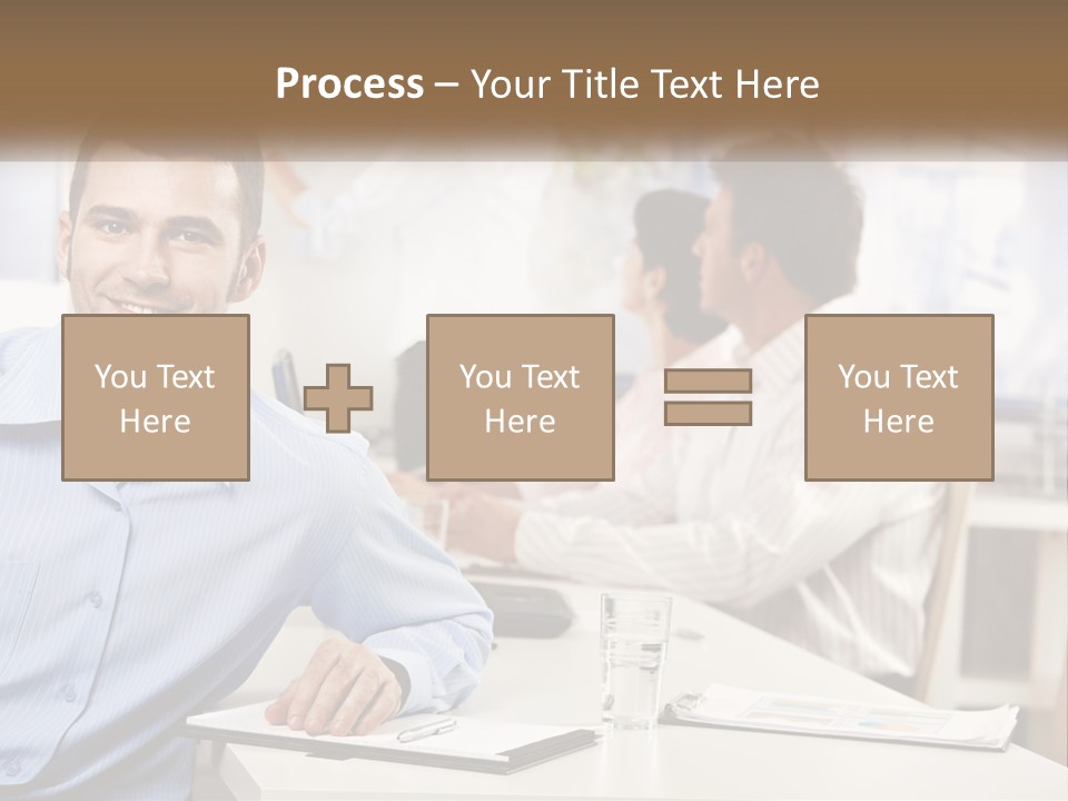A Man Sitting At A Desk In Front Of A Group Of People PowerPoint Template