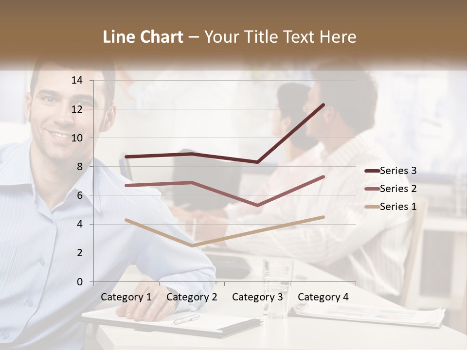 A Man Sitting At A Desk In Front Of A Group Of People PowerPoint Template