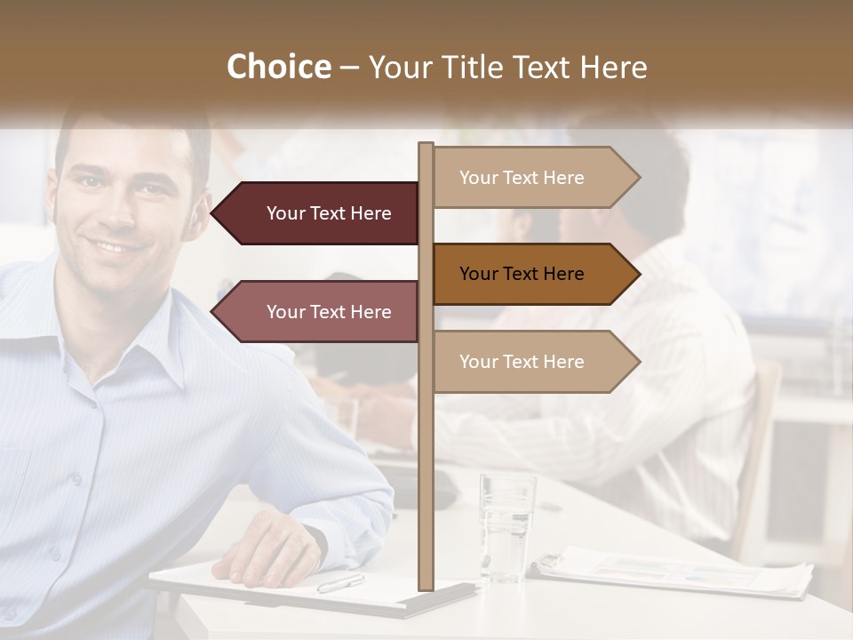 A Man Sitting At A Desk In Front Of A Group Of People PowerPoint Template