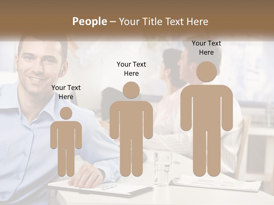 A Man Sitting At A Desk In Front Of A Group Of People PowerPoint Template