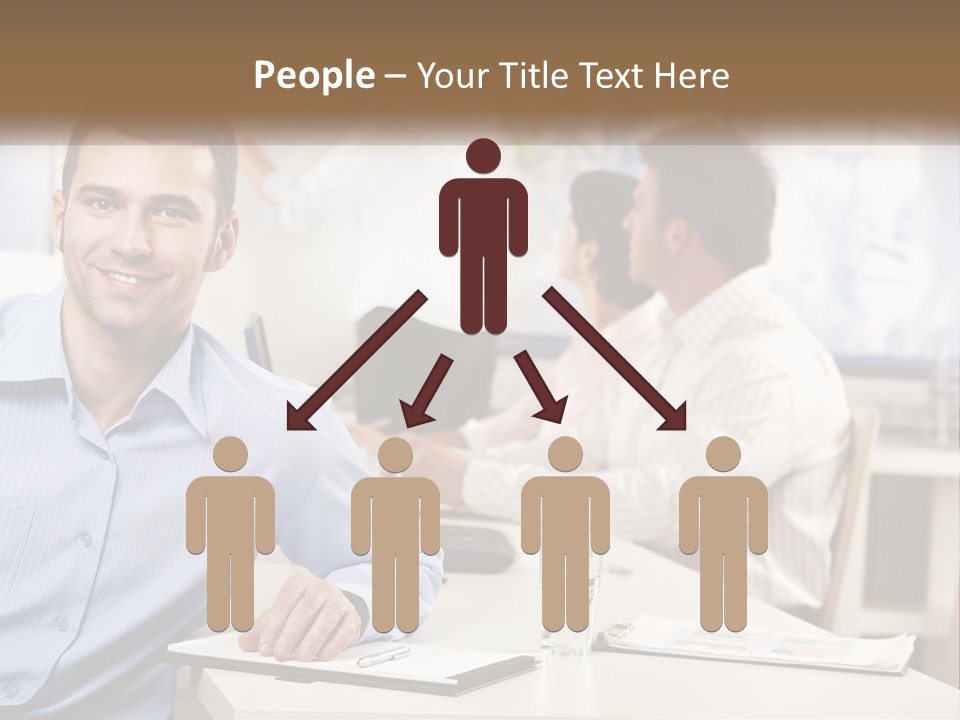A Man Sitting At A Desk In Front Of A Group Of People PowerPoint Template