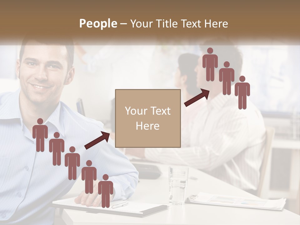 A Man Sitting At A Desk In Front Of A Group Of People PowerPoint Template