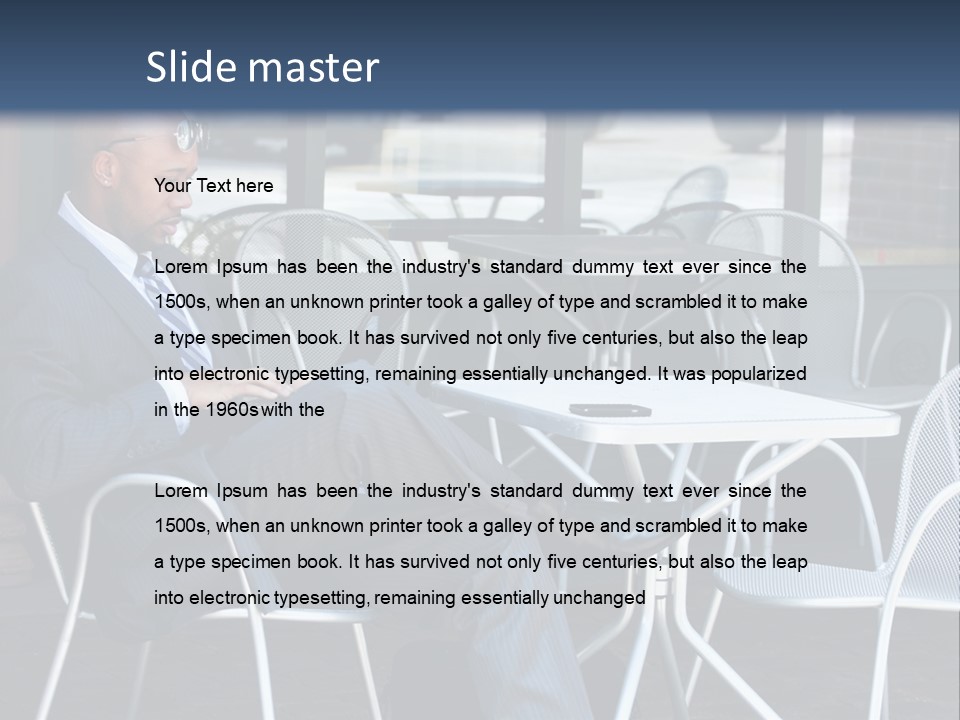 A Man In A Suit Sitting At A Table With A Laptop PowerPoint Template