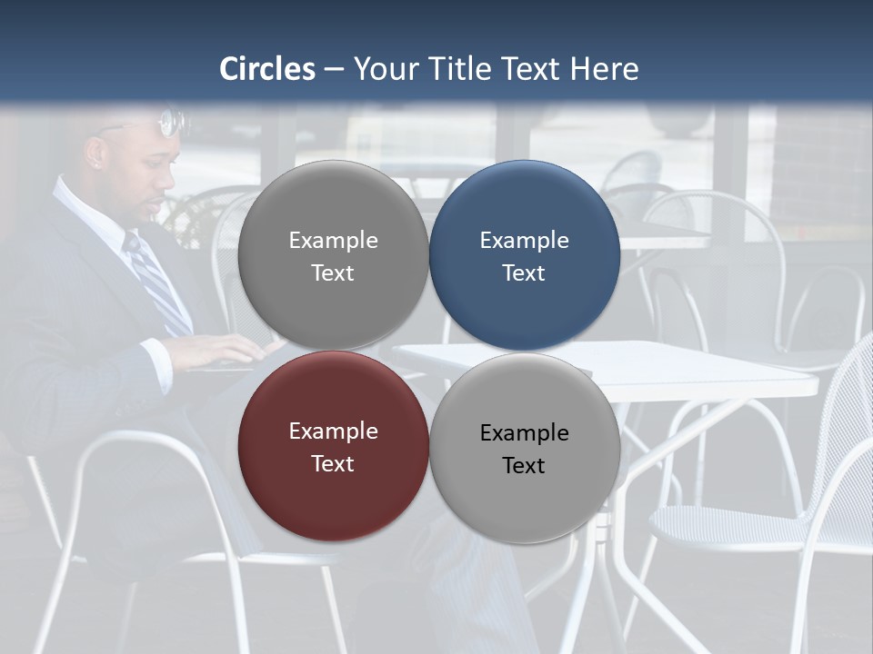 A Man In A Suit Sitting At A Table With A Laptop PowerPoint Template