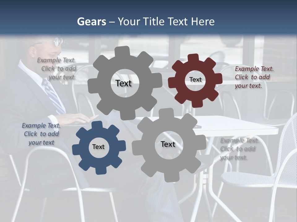 A Man In A Suit Sitting At A Table With A Laptop PowerPoint Template