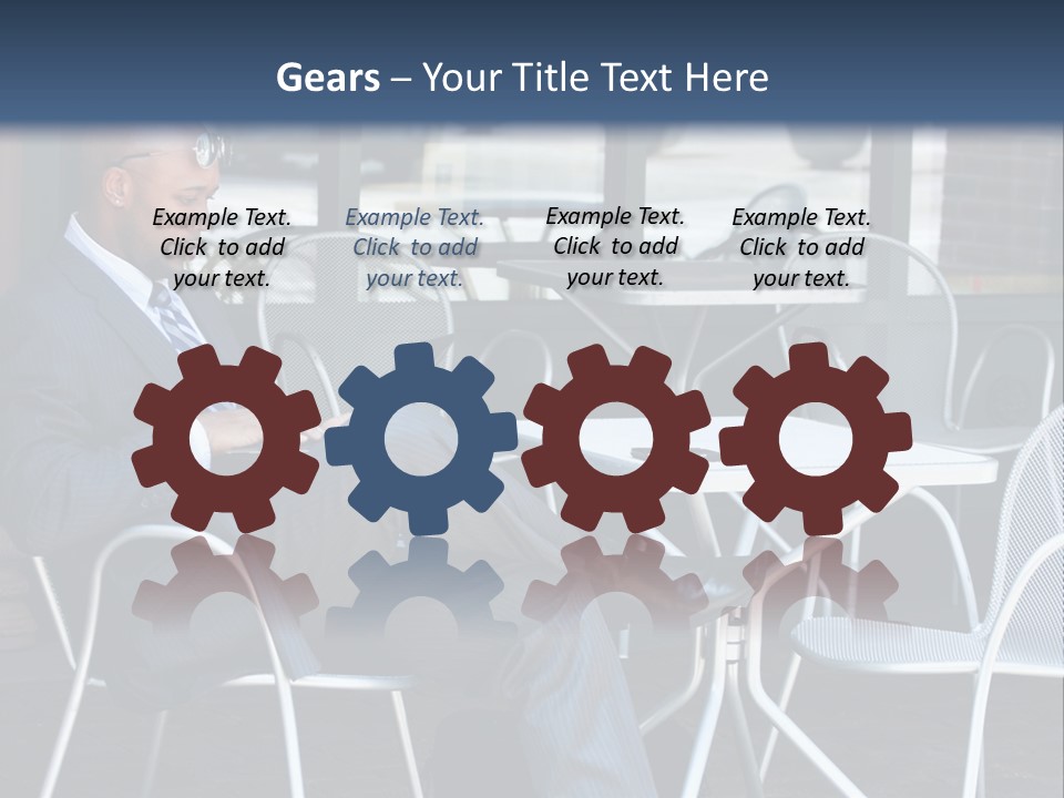 A Man In A Suit Sitting At A Table With A Laptop PowerPoint Template